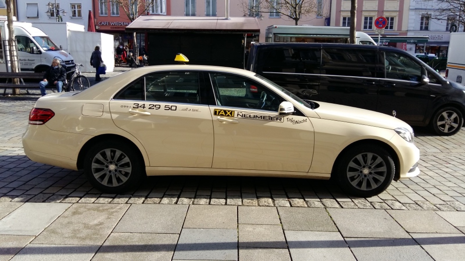 Mercedes E-Class saloon operating as a taxi with Taxi Neumeier lettering in the centre of Deggendorf